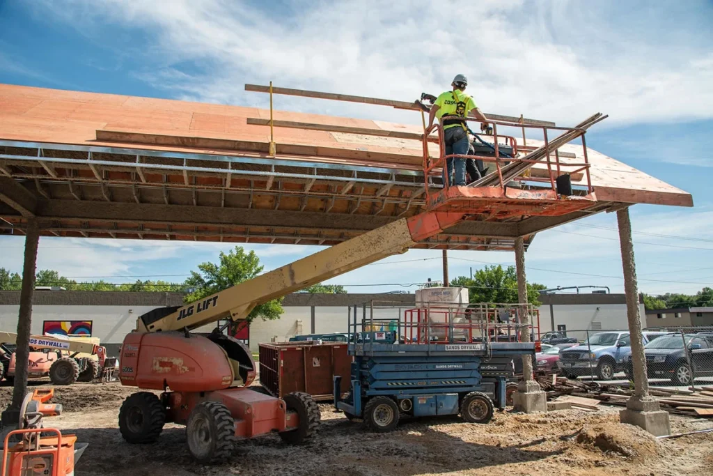 Cosand employees in a telehandler working on Dow Rummel rough carpentry